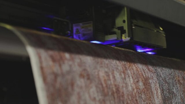 Modern wallpaper factory. Industrial printer making new wallpaper sample. Wallpaper production. One of step creation new wallpaper. Closeup