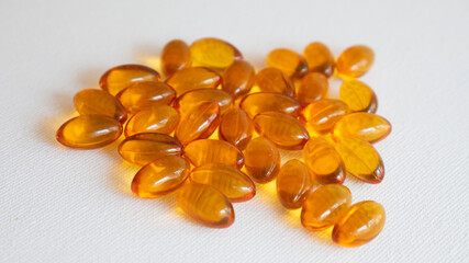 Fototapeta na wymiar Fish oil pills on white background.