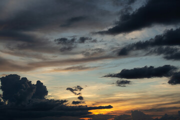 Fototapeta na wymiar Beautiful sunset sky above clouds with dramatic light.