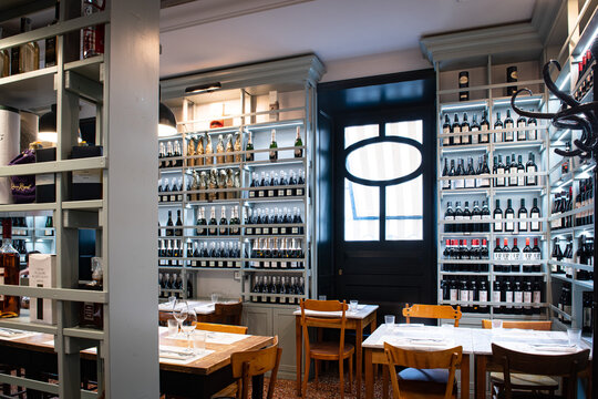 Wine Shop Room With Tables And Large Choice Of Bottles On Shelf