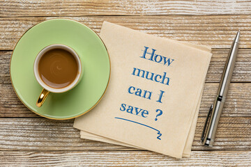 How much can I save? Handwriting on a napkin with a cup of coffee. Personal finance concept.