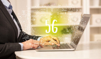 hand working on new modern computer with 5G abbreviation, modern technology concept