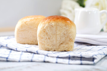 Fresh home made bread on white table background with napkin