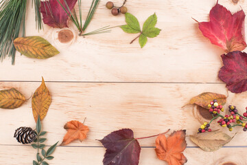 fallen leaves on wooden background, top view.