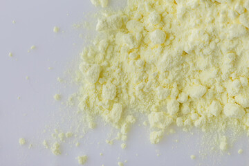 purified sulfur powder on a white acrylic background