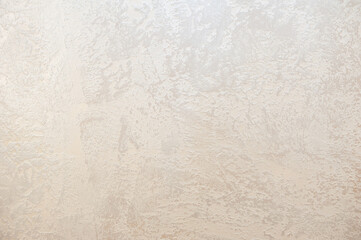 Wall decor Venetian decorative plaster with golden glitter paint. Background, abstraction. Apartment renovation concept.