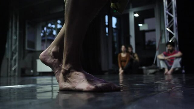 A close up of a dancer steps in slow motion