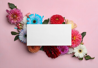 Flat lay composition with blank card, dahlia and gerbera flowers on pink background. Space for text