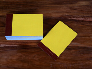 Yellow color bill books or receipt books on a wooden surface