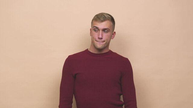 Young caucasian man confused, feels doubtful and unsure