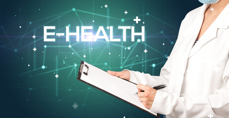 Doctor fills out medical record with E-HEALTH inscription, medical concept