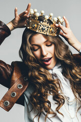 dynamic woman in leather jacket with golden crown