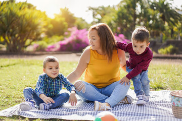 Mother enjoy day with twin sons in nature park - Family, single parent and child love