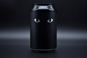 two drawn eyes on a black background. two cat eyes drawn on a black background on an aluminum can