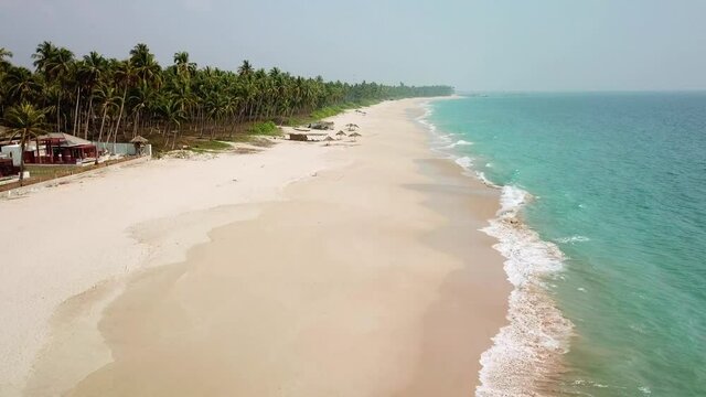 Dronefootage from a lonely beach near Ngapali in Myanmar. Flying along the coastline above the beach and beach huts