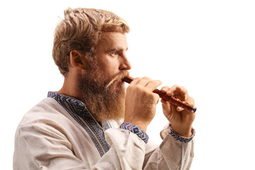 Close-up shot of a young man playing a wooden flute © Ljupco Smokovski
