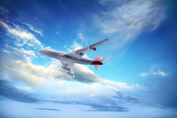 Fototapeta na wymiar Airplane flying in blue sky with clouds. Air transportation