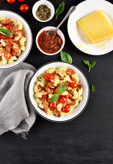 Pasta with bacon, tomato, parmesan cheese and basil leaves