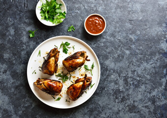 Roasted quails on plate