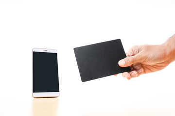 A smartphone and a hand holding a black card on white background 