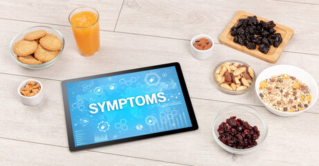 Healthy Tablet Pc compostion with SYMPTOMS inscription, immune system boost concept