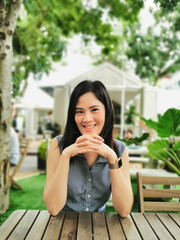 An Asian woman feeling happy and smiling in the garden