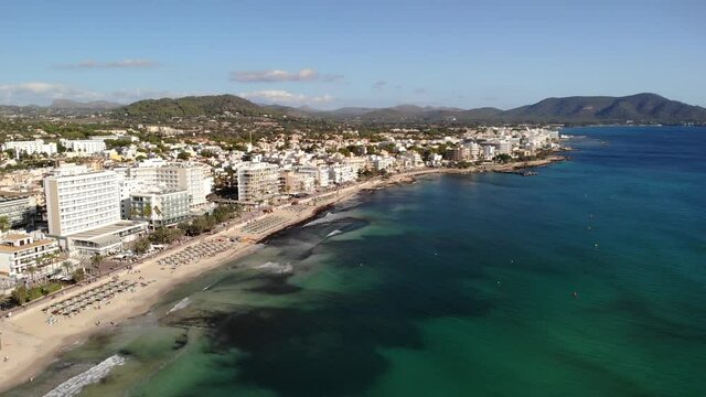 Mallorca Balearic Island, Spain. Cinematic Aerial View of Cala Millor Beachfront Hotels and Resorts on Summer Day, Drone Shot