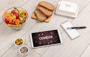 Fototapeta premium Healthy Tablet Pc compostion with COVID19 inscription, immune system boost concept