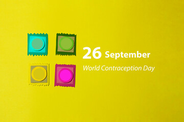 Four mock-ups of the condom were cut out of colored paper on a yellow background. Photo card of...