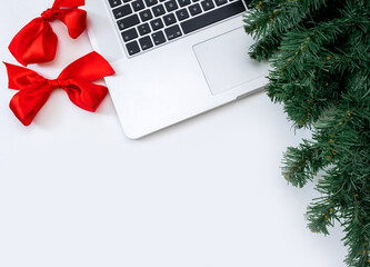 Laptop gifts white background christmas tree red hat new year copy space top view