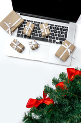 Laptop gifts package box white background christmas tree red hat new year delivery top view
