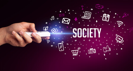 hand holding wireless peripheral with SOCIETY inscription, social media concept