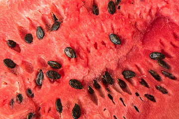 The pulp of a red ripe watermelon with seeds