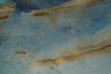 .Blue-gold background. Shiny paint and paper back texture.