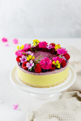 Cashew cake with raspberries and lemon, garnished with flowers. Sugar, lactose, gluten free. Healthy food, no baking.