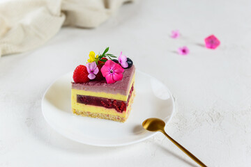 Slice of lemon raspberry cashew cake on a white plate. Sugar, lactose, gluten free. Healthy food, no baking.
