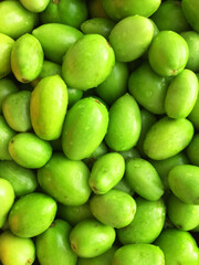 green tomatoes lie in a plate, tomatoes on a white background. red tomato

