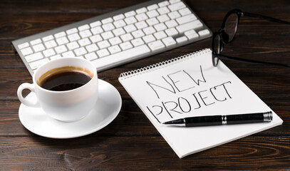 office desk with laptop, notebooks and coffee cup on wooden background.