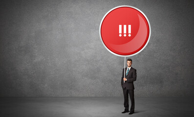 Obraz premium Young business person holdig traffic sign with !!! abbreviation, technology solution concept