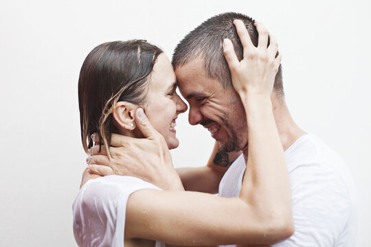 &ndash;&deg;ouple in white t-shirts under a stream of water