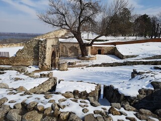 Ruins grave yard historical site landmark in Belgrade serbia castle fortress city winter white snow no leafes trees wall