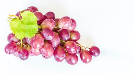 a bunch of pink grapes on a white background. grapes close-up view from above. background with red grapes.