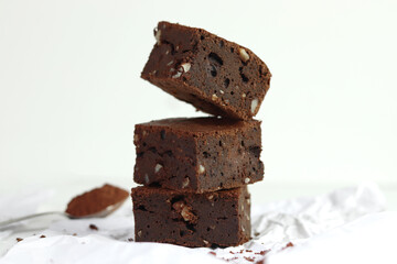 Front view of homemade chocolate brownie with walnut on white background.
