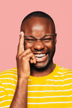 Portrait of handsome black man looking at camera while laughing