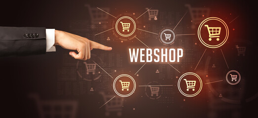Fototapeta na wymiar Close-Up of cropped hand pointing at WEBSHOP inscription, online shopping concept
