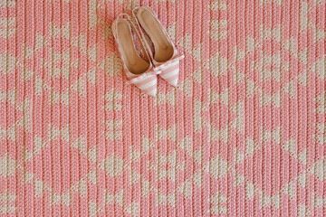 Shoes placed on pink carpet