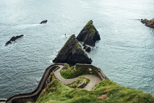 Winding coastal path along the grass cliffs above the ocean