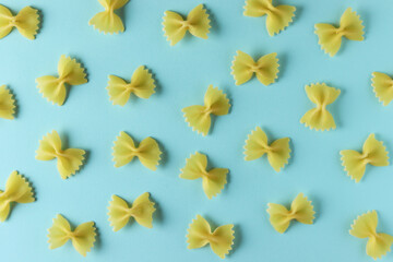 Farfalle pasta random flat lay pattern on blue background