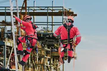 Work at height, wear safety harnesses and climb stairs and abseiling in construction site