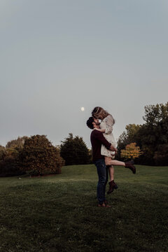 A young engaged couple posing for portraits